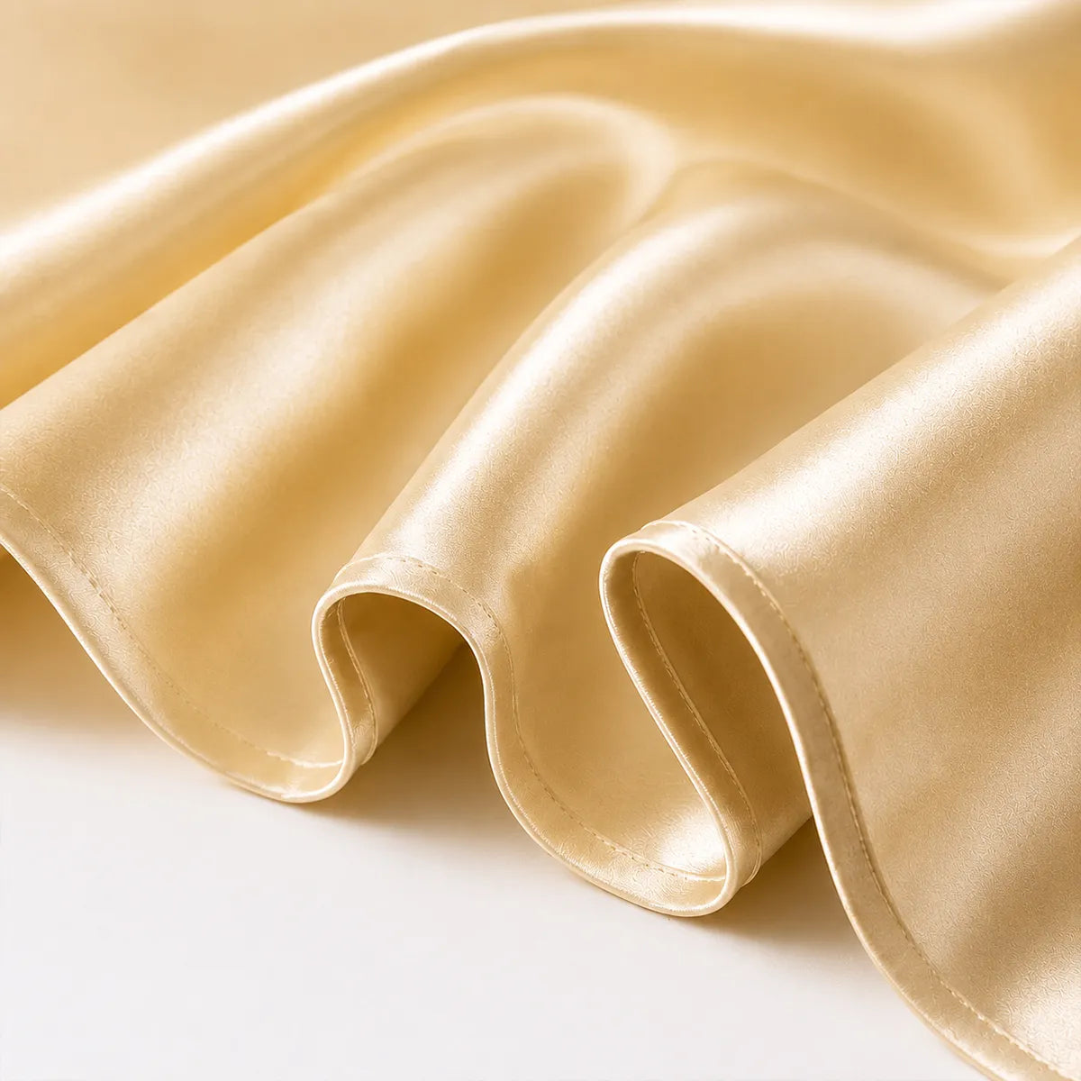 Champagne silk fabric with smooth folds and soft sheen